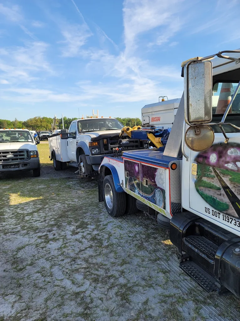 Commercial truck with trailer at outdoor equipment lot under blue sky